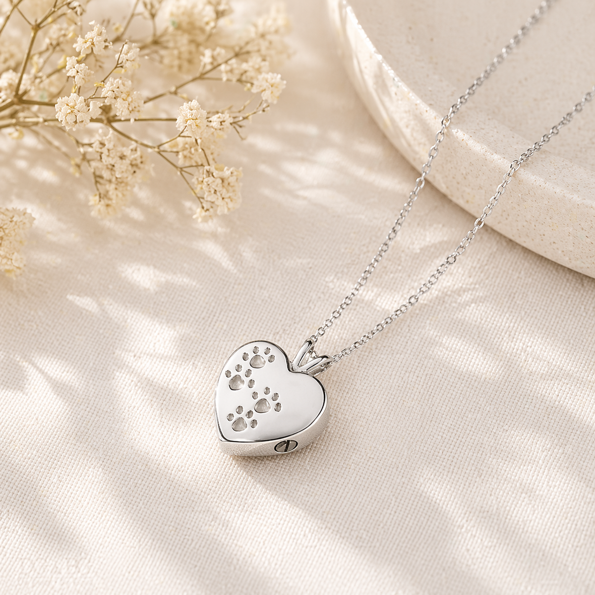 Pet Memorial Necklace for Ashes featuring heart and paw print design in stainless steel
