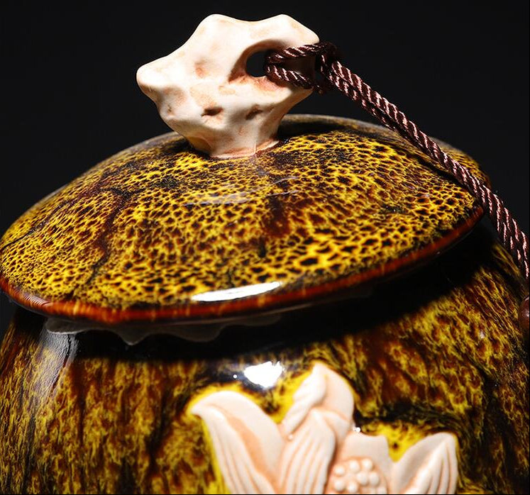 Decorative ceramic jar with textured surface and decorative elements on a black background