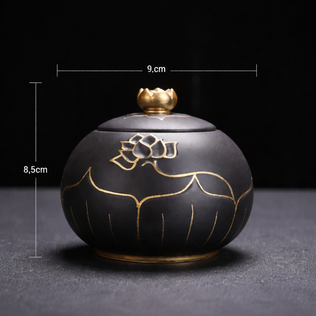 Black ceramic container with gold floral designs and measurements on a dark background